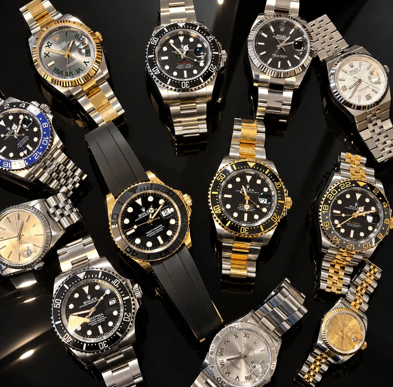 Auswahl verschiedener Rolex-Uhren auf schwarzem Grund